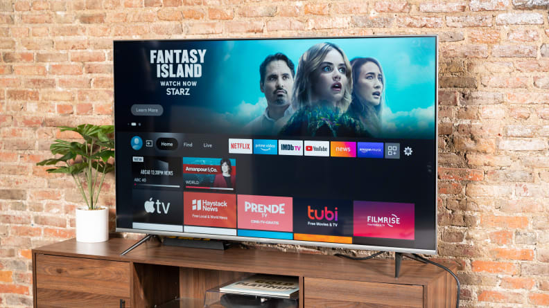 The Amazon Fire TV Omni displaying its smart platform's home screen in a living room setting