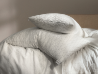 Coop Home original pillows sit on top of a bed