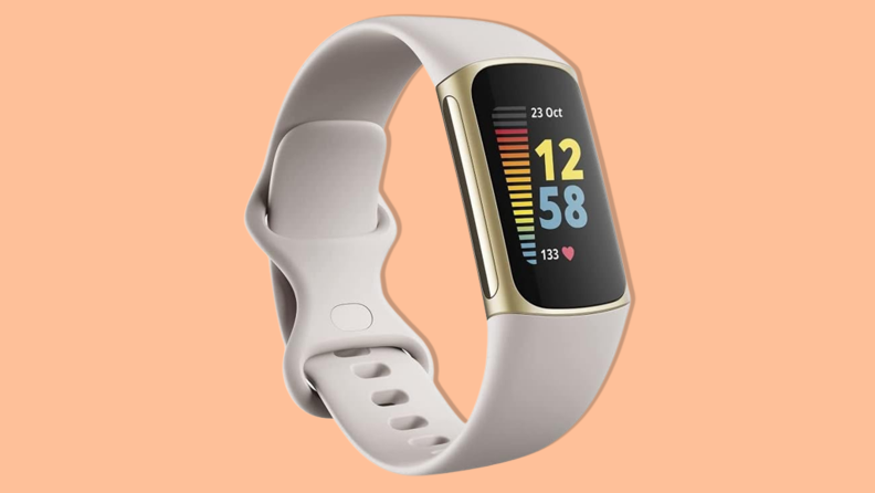 Fitbit Charge 5 on an orange background.