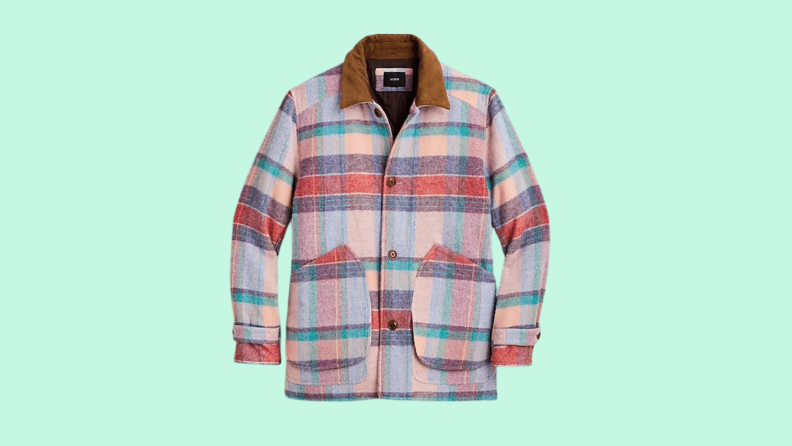 A pink plaid wool coat against a green background.