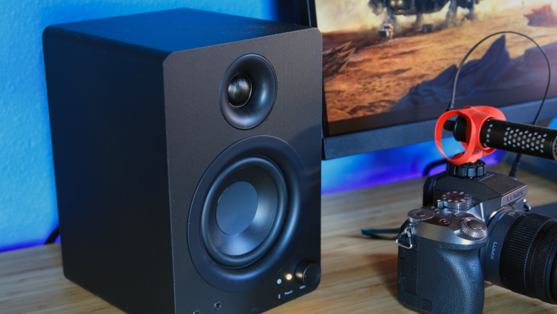 The Monoprice DT-3BT 50-watt desktop speakers on a desktop.