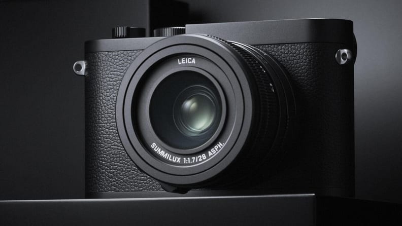A small black camera against a black and gray background