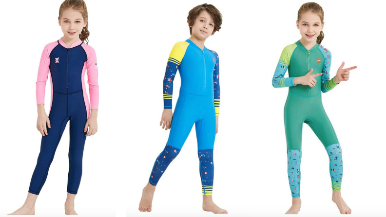 Three young kids wearing full-body bathing suits in various colors.