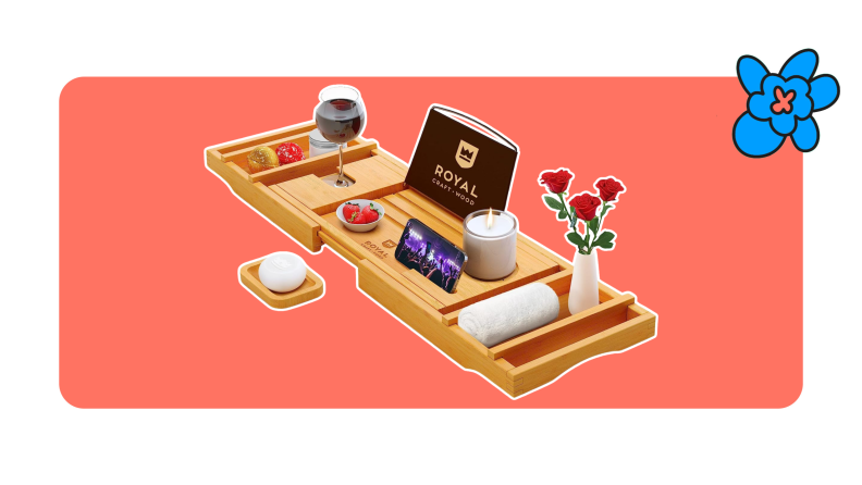 A Royal Craft wooden bath tray with assorted self-car items, a vase of red roses and a glass of wine.