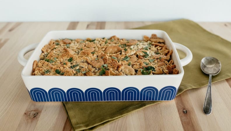 A hot dish on a wooden table with food inside