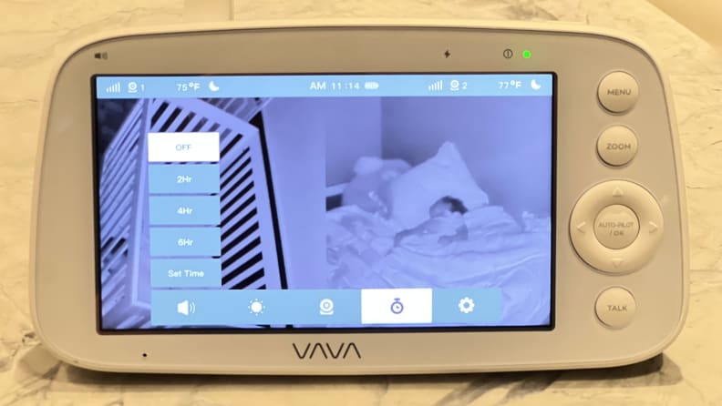 The Vava monitor screen showing the working interface and two sleeping toddlers.