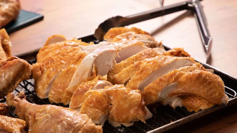 Sliced turkey on a baking sheet.