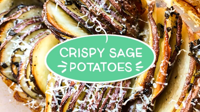 Cheesy, thinly sliced potato rounds in a glass baking dish with text overlaid that reads as follows: crispy sage potatoes.