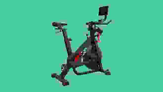 Black Bowflex exercise machine on green background