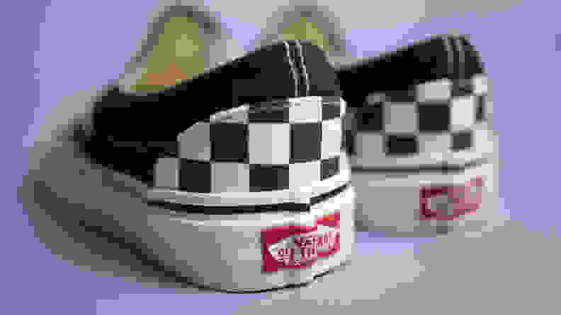 Close-up shot of the back of the Vans Checkered slip-ons, revealing the Vans logo.