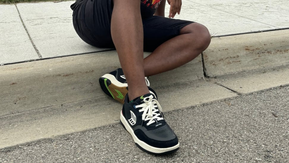 A man wearing a pair of Cariuma UBA Pro sneakers.