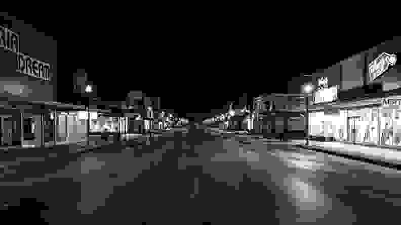 A photo of a deserted downtown street in McAllen, Texas, taken after dark.