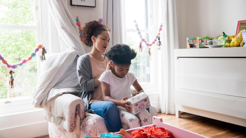 Mother doing daughter's hair