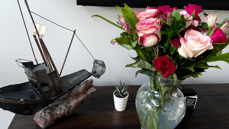 Proflowers in a vase next to a ship