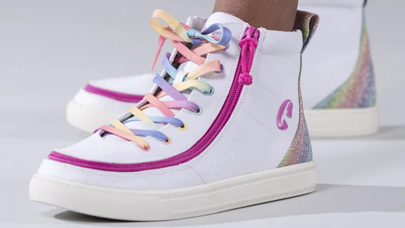 A white sneaker with a pink zipper