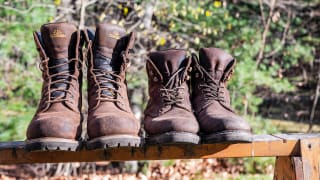The best work boots: Two pair of work boots sitting on top of a work bench.