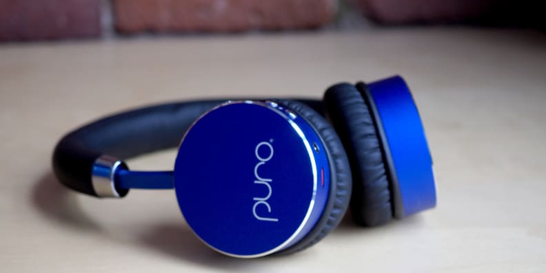 A pair of blue Puro BT2200 headphones lying on their side.