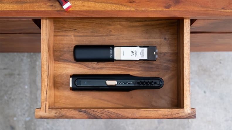 The L'Oréal Colorsonic separated into two parts and placed inside a drawer.