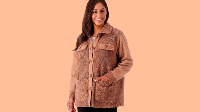 An image of a camel sherpa jacket from Idina Menzel's clothing line. The jacket has four front pockets, and the sherpa texture is finer on the sleeves.