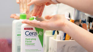Photo of the best face wash we tested from CeraVe sitting on bathroom vanity in front of a mirror.