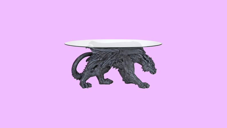 A glass table with a dragon support in front of a background.