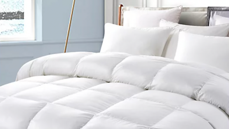 A white duvet made on a bed.