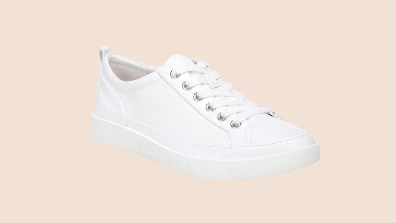 white sneakers on beige background
