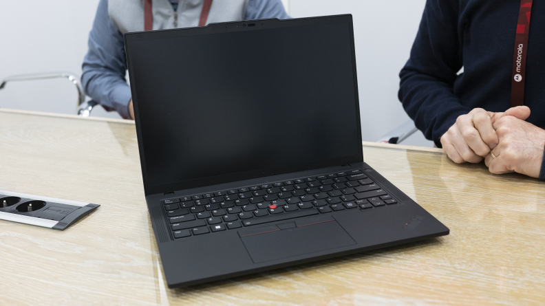 The Lenovo T14 laptop sitting on a wooden counter.