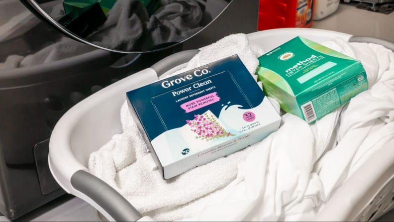 A box of Grove Co. Power Clean laundry sheets in a basket.