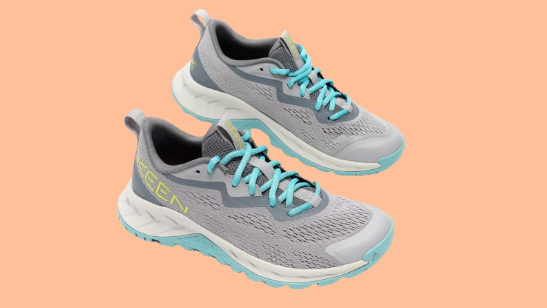 teal and grey athletic sneakers on orange background