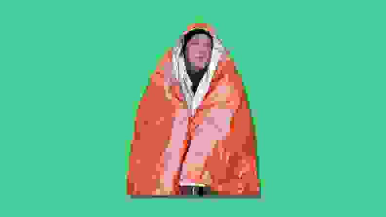 A man wrapped in thermal blanket.