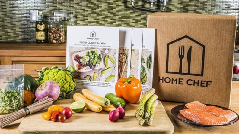 Home Chef box with ingredients and menu cards in front