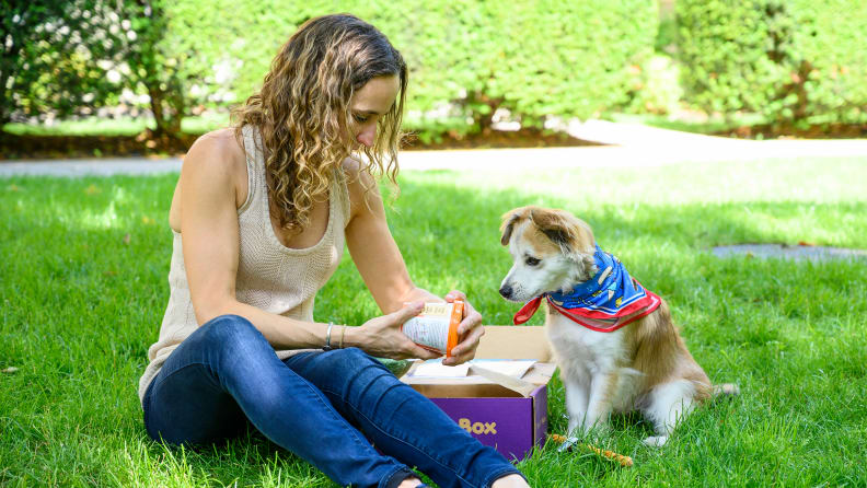A woman reading the ingredients on dog ice cream inside a PupBox