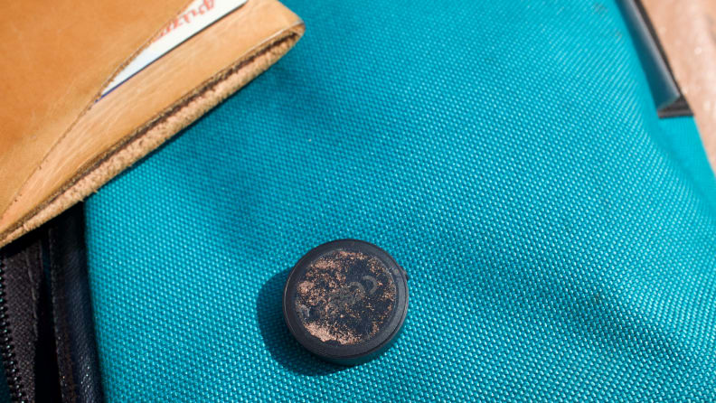 The underside of Tile's Sticker tracker, showing the worn adhesive.