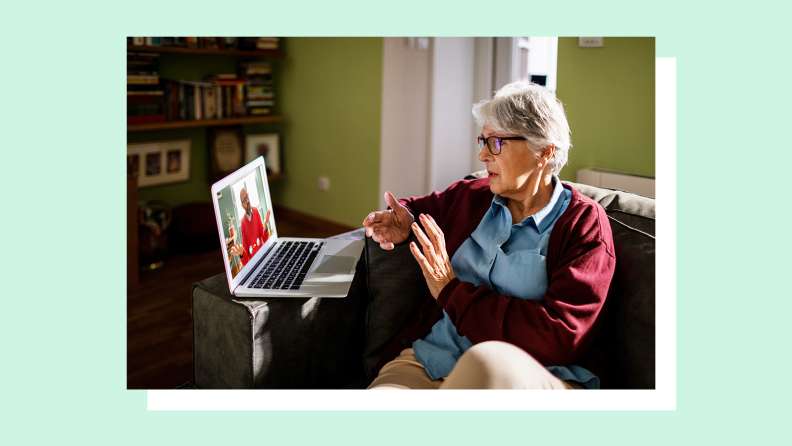 An older woman gestures while speaking to a man in an orange cardigan on her laptop screen.