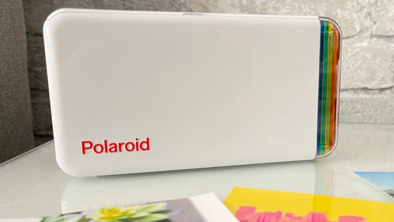 The Polaroid Hi-Print portable photo printer sitting on a counter top.