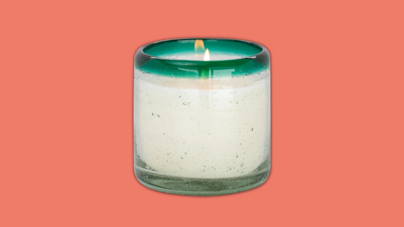 A Paddywax candle against a red background