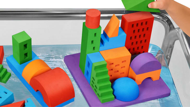 A colorful set of buoyant toy blocks with a city-scape printed on them.