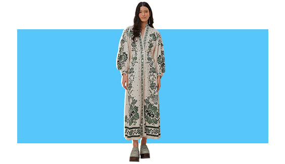 A model wearing a white and blue printed maxi dress.