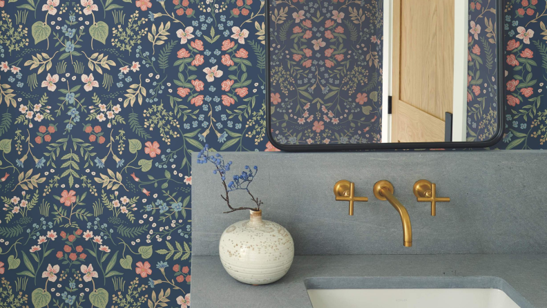 Bathroom sink with dark blue and pastel wallpaper