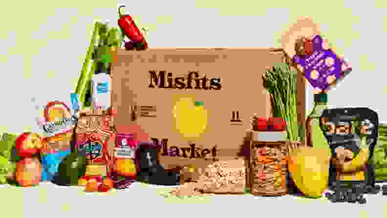 A box of Misfits Market surrounded by food.