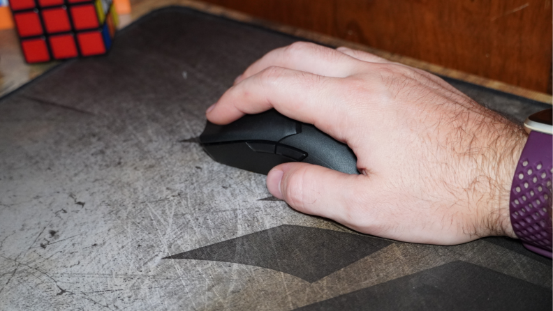 Person using hand to hold Razer Viper V2 Pro mouse.