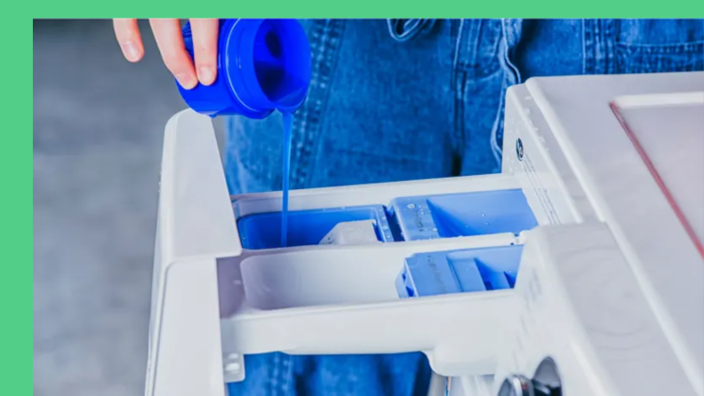 Person adding liquid detergent to a washer