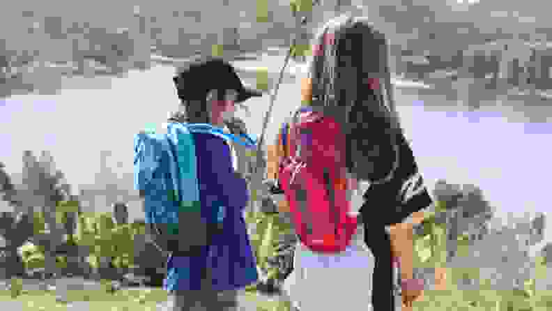 Two kids wearing Camelbak hydration packs: The Scout and the Mini M.U.L.E.