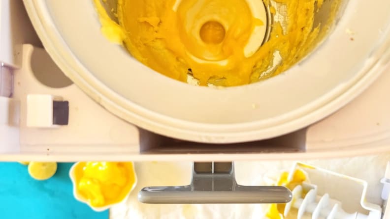 A yellow sorbet mess inside of the Cuisinart Mix It In Soft Serve Ice Cream Maker.