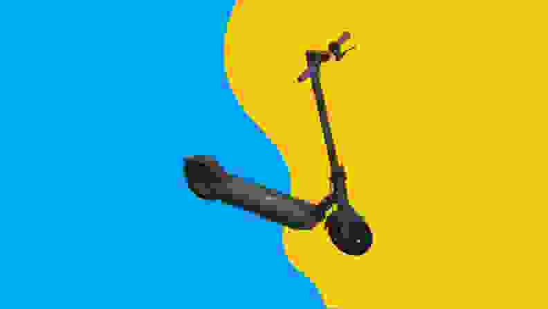 A black scooter against a blue and yellow background.