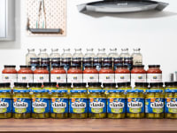 Four rows of jars in the Reviewed test lab kitchen: Vlasic Kosher Dill Speaers, 365 Marinara sauce, lemonade, and more.