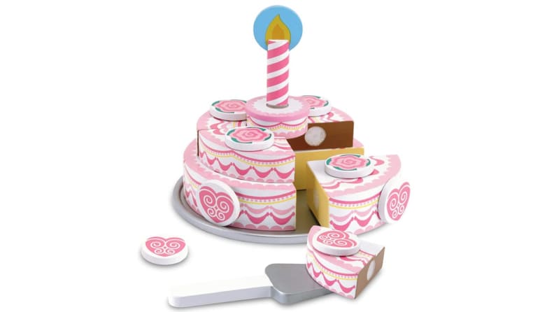 Pink and white wooden tiered children's cake with slice missing.