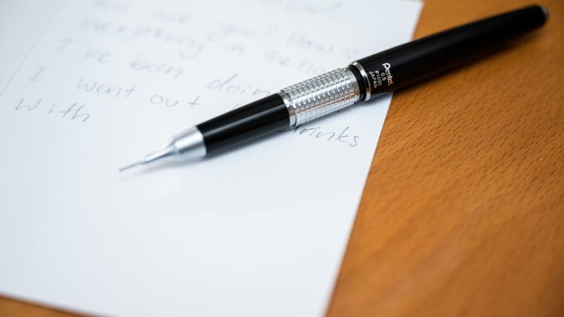 A Pentel Kerry Mechanical Pencils sits on a desk, next to a hand-written note.