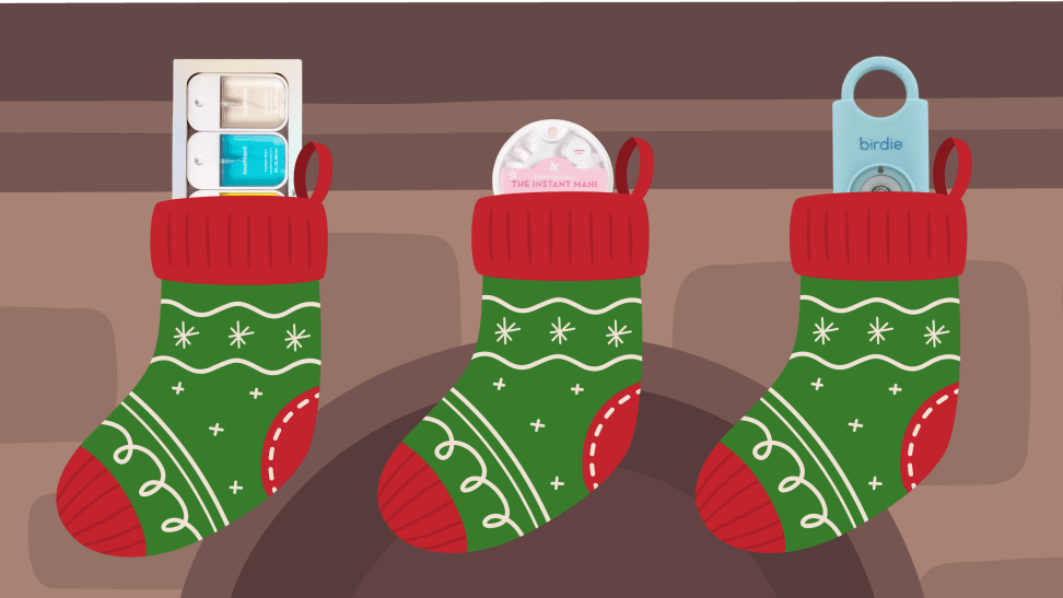 Three gifts stuck in three stockings hanging on a mantel